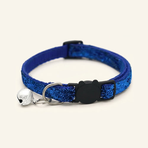 Glittery blue adjustable cat collar with a cat-shaped black buckle and a silver bell on a cream background.