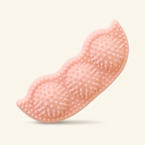 A pink, pea-pod-shaped textured dog chew toy with rubbery spikes.
