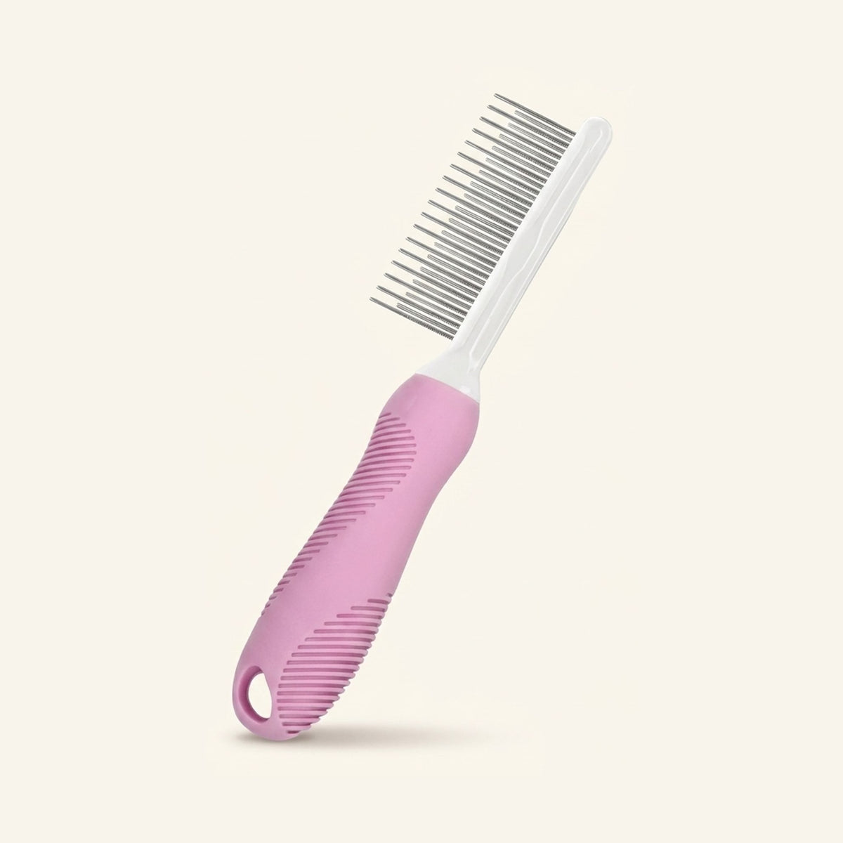 A pink and white pet grooming comb with metal teeth on a plain cream background.