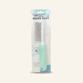 A pet grooming needle comb with a mint green textured handle in its packaging
