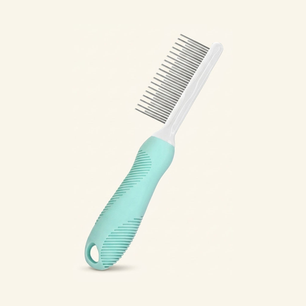 A mint green and white grooming comb with metal pins and a textured grip on a plain cream background.